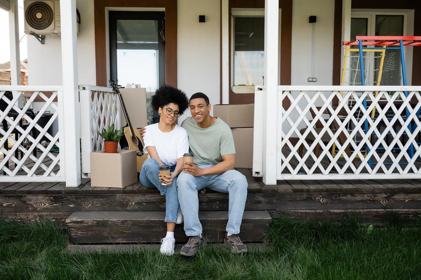 A young couple standing on the porch of their first Central Florida home.