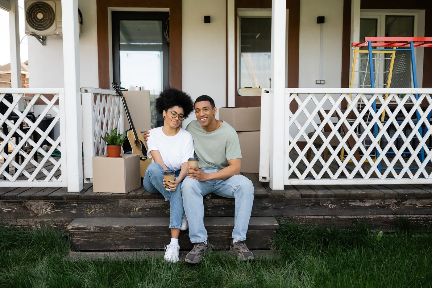 A young couple standing on the porch of their first Central Florida home.