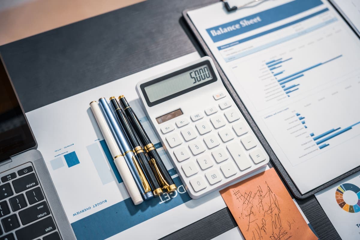 A close-up of a mortgage closing disclosure statement and a calculator.